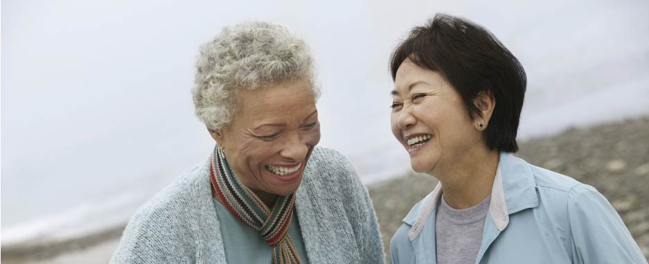 Two elderly women smiling and laughing